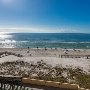 Enjoy breathtaking views of the beach from this inviting balcony, perfect for relaxation and seaside memories