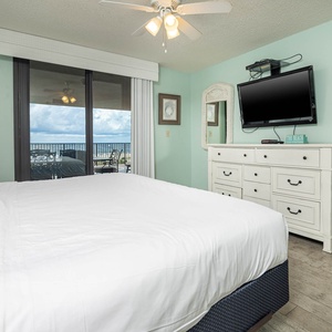 Enjoy restful nights in this inviting master bedroom with a king bed and access to the extended beachfront balcony