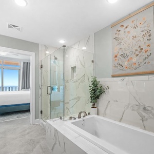 Indulge in relaxation in the master bath with a refreshing and elegant glass shower and soothing tub