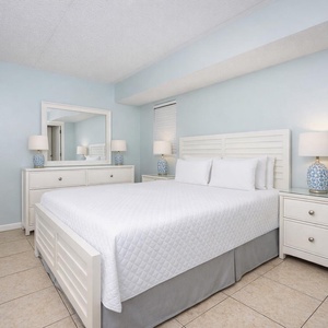 This bedroom features a comfortable bed, stylish decor, and ample storage for a relaxing stay