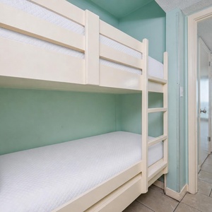 Bunk beds in the hallway offer a cozy spot for the kids after fun-filled days along the coast