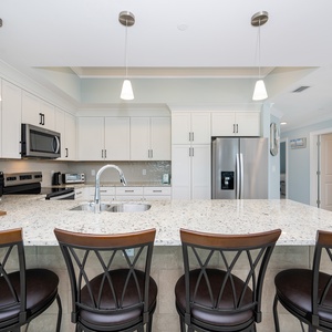Gather around the sleek kitchen for morning coffee, perfect for enjoying time with loved ones