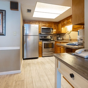 The kitchen features granite countertops, stainless appliances, and a cozy dining area, perfect for a delightful meal