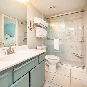 Refresh in the bright bathroom featuring a spacious vanity, modern fixtures, and a walk-in shower