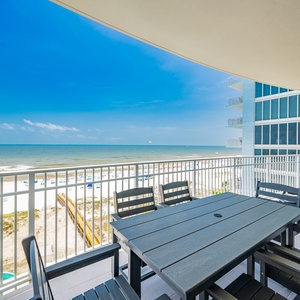 Enjoy meals at the outdoor dining table while taking in refreshing views of the tranquil waters and beach activities