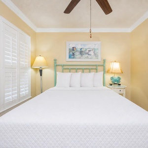 Savor restful nights on a plush queen bed, surrounded by calming colors and beach decor in the guest bedroom
