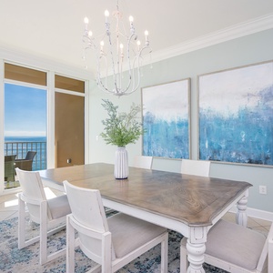 Dine in style surrounded by coastal views as natural light fills the inviting dining area