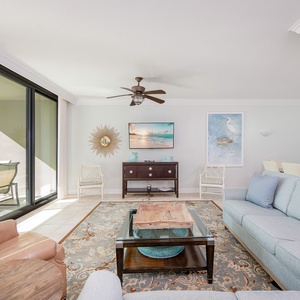 Unwind in the inviting living room with a queen sofa sleeper, feeling the warmth of the sun from the balcony