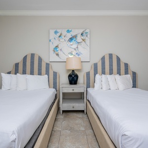 Rest in the serene comfort of accommodating queen beds, inviting peaceful nights and tempting morning beach walks