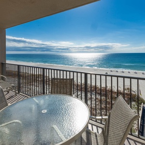 Savor meals at the round table on the balcony, enjoying expansive views of the shimmering waters and shoreline