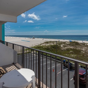 Enjoy a relaxing view from the balcony overlooking the beach, perfect for unwinding after a day of fun
