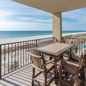 Enjoy meals or drinks at the outdoor table while taking in the expansive views of the tranquil water and beach