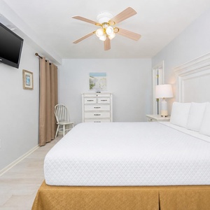 Rejuvenate in this guest bedroom with a queen bed, where soft bedding invites restful nights and peaceful mornings