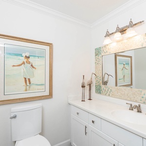 Additional half bath featuring a stylish mirror, elegant decor, and ample counter space for your essentials