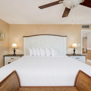 White linens and plush pillows invite you to rest deeply in the king master suite surrounded by soft lamplight