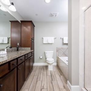 Indulge in relaxation in the master bath with a refreshing walk-in shower and soothing jetted tub