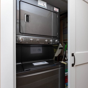 Convenient and sleek stacked washer and dryer tucked away in a stylish closet for effortless laundry during your stay