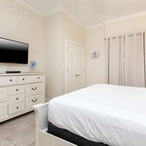 Relax on the cozy king bed in this guest suite and stream your favorite shows after a beach day