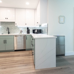Prepare meals in this stylish kitchen with a sleek design, modern appliances, and elegant tile accents