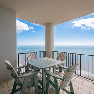 Stunning views from the balcony, featuring a cozy table and chairs perfect for relaxing seaside moments