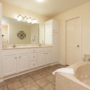 Indulge in relaxation in the master bath with a refreshing walk-in shower and soothing jetted tub