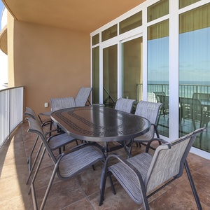 Savor coastal breezes while gathering at the balcony table overlooking the beach