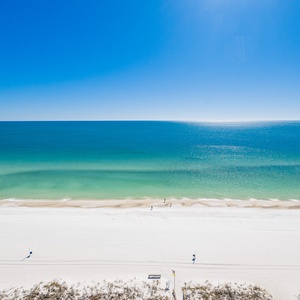 Look out over the sparkling coast from your balcony as gentle waves meet the shore below
