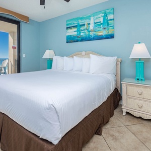 Unwind in the serene master bedroom with a king bed, vibrant decor, and beachfront balcony access