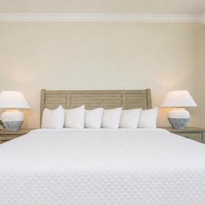 Awaken in this master suite surrounded by soft pillows and the gentle sound of the waves, perfect for restful nights