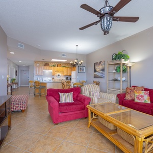 Relax in the spacious living area, featuring colorful seating and a dining table for shared meals and laughter