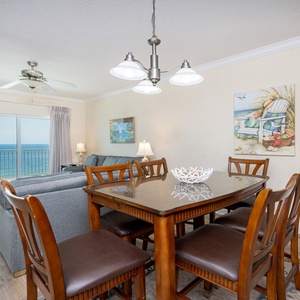 Bright dining area with a glass table, comfortable seating, and breathtaking views of the tranquil waters beyond