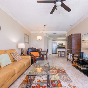 Relax in the inviting living area, featuring comfortable seating and a vibrant area rug for a cozy vibe