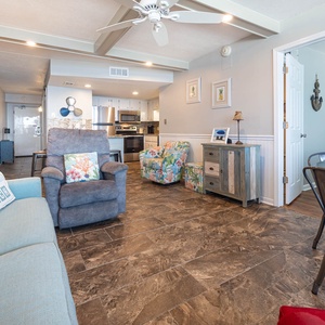 This inviting living area features comfortable seating, a stylish dining space, and a glimpse of the well-equipped kitchen