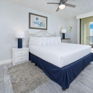 King master suite welcomes you with plush linens and serene art beside your balcony's sparkling beach view
