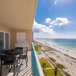 A gentle breeze sweeps across the balcony as you admire the vast blue sky and coastline below