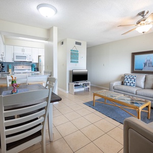 This inviting living area features a cozy couch, a TV, and a dining table, perfect for relaxing after a day of fun