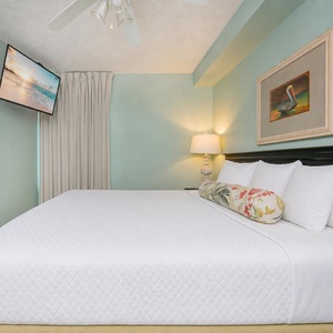 Relax in this inviting bedroom featuring a comfortable king bed, a flat-screen TV, and soft, calming wall colors