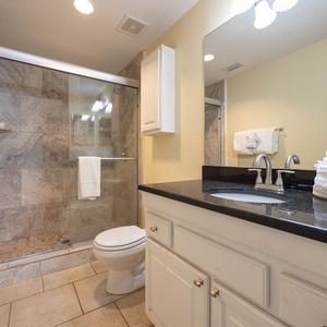 Refresh in the stylish master bathroom featuring a spacious walk-in shower, sleek countertops, and soft towels
