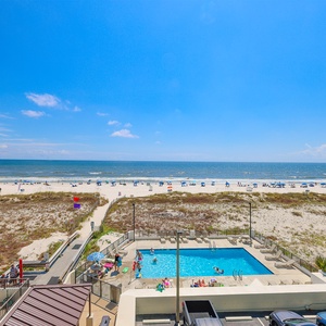 Enjoy breathtaking beachfront views from this inviting space, complete with a refreshing pool and vibrant beach activities