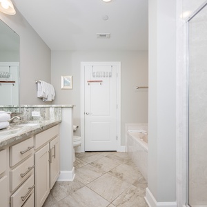 Refresh in the master bath after a day at the beach with a soothing jetted tub and relaxing walk-in shower
