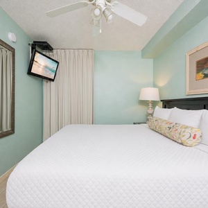 Fluffy pillows invite you to relax in the king suite for a calm movie night after a fun day at the beach