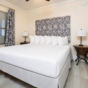 Sleep peacefully in this inviting guest bedroom featuring a queen bed, decorative pillows, and stylish curtains