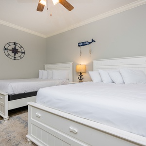 Rest in the soft queen beds in this guest room, embracing peaceful nights that soothe you after fun days at the beach