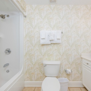 Enjoy a relaxing shower after a day of adventure in this guest bath with stylish accents and fluffy towels