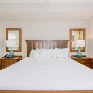 Relax in this inviting master bedroom featuring a plush king bed, stylish decor, and soothing natural light