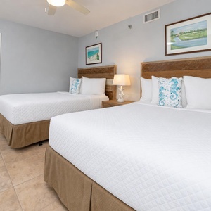 Relax in either the cozy queen bed or plush double bed in this guest suite with coastal accents and enjoy a peaceful retreat