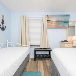 Sink into soft, fluffy bedding as you unwind and watch your favorite shows on the TV in this guest suite