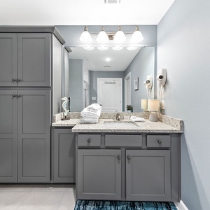 Start your day in a refreshing way in the guest bath with a stylish vanity and shower area