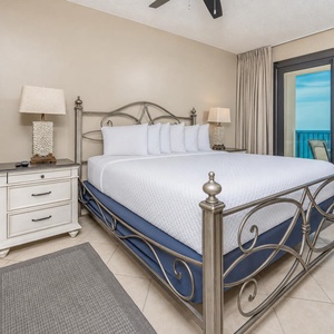 Unwind in this serene master bedroom featuring a king bed, stylish decor, and beachfront balcony access