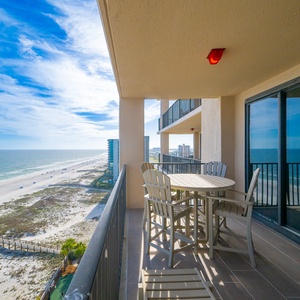 Gentle waves hum below as you relax on your balcony with a view stretching along the coast